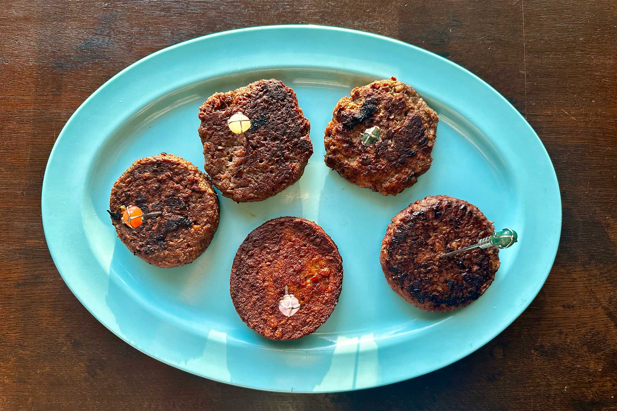 5 plant-based burger patties on a white plate