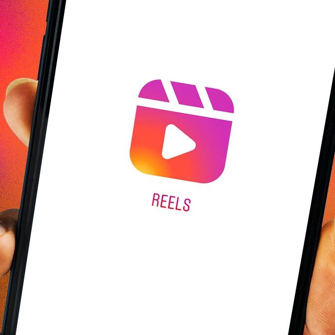 Hand holding phone with instagram reels app