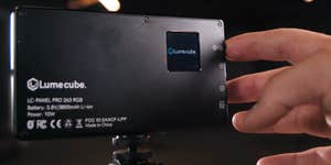 hand pressing button on Lumecube