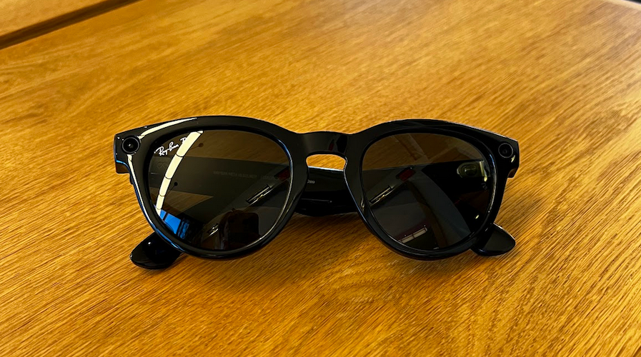 Ray-Ban's meta smart glasses sitting on a wooden desk 