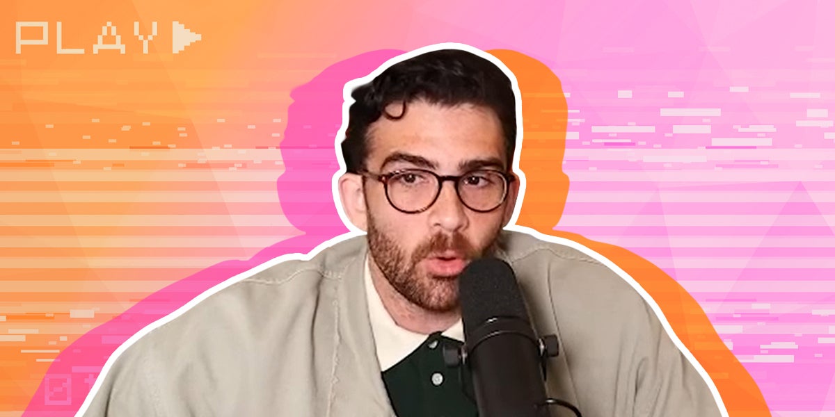 hasan piker speaking into a microphone with a video playing in the background