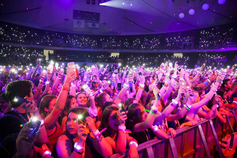 what is vidcon - a crowd shot from vidcon of screaming fans with their phones up in the air recording