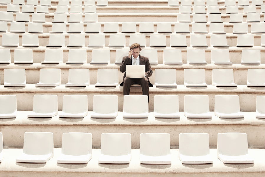 what is a solopreneur - man sitting alone in an ocean of chairs