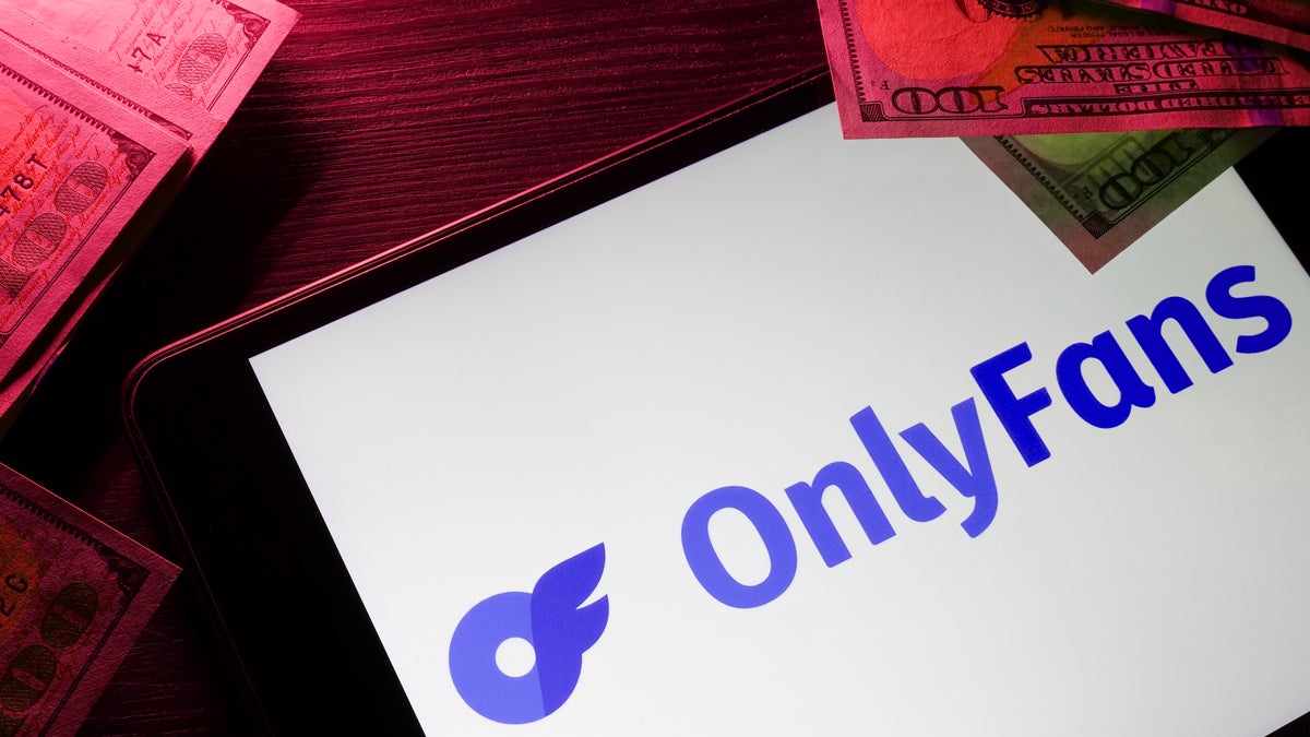 OnlyFans on tablet and money