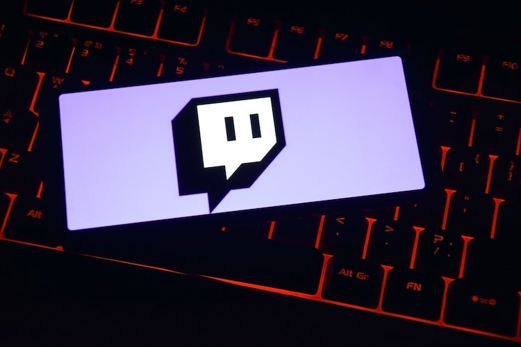 Monetization guide - twitch, a phone with the twitch logo in front of a keyboard