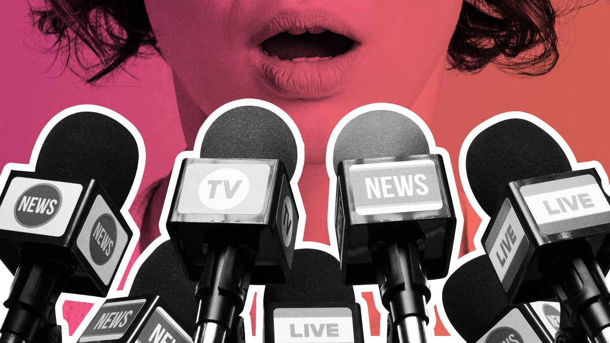 Woman talking with news microphones in front of her