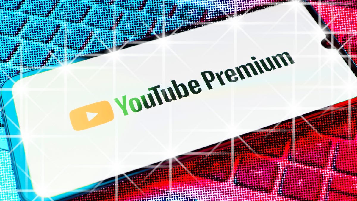 Phone over keyboard with YouTube Premium and the screen sparkles