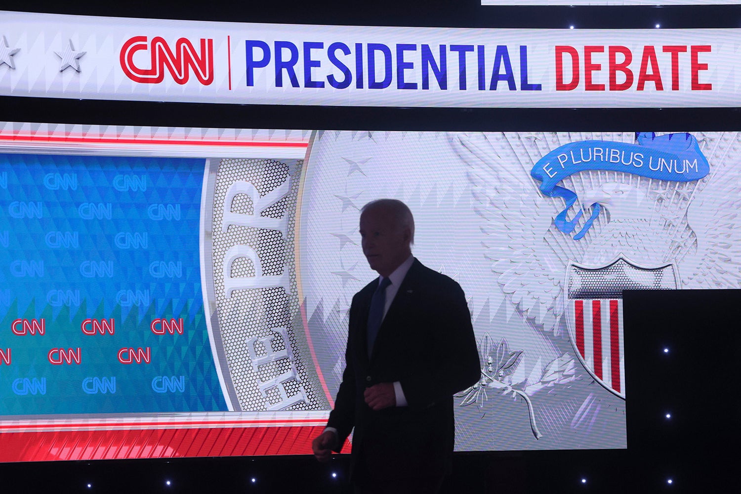 President JOE BIDEN walks back on stage after a commercial break debating former PresidentTrump at CNN