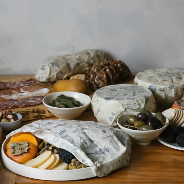 A variety of bowls of food covered by Abeego beeswax wraps