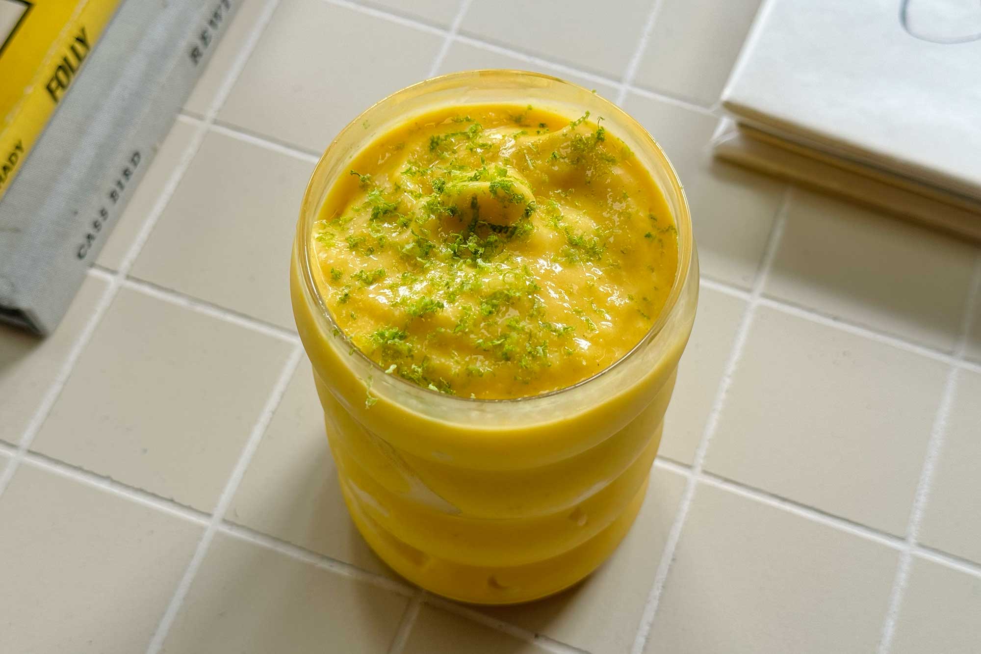 A ball jar filled with a frozen mango lassi