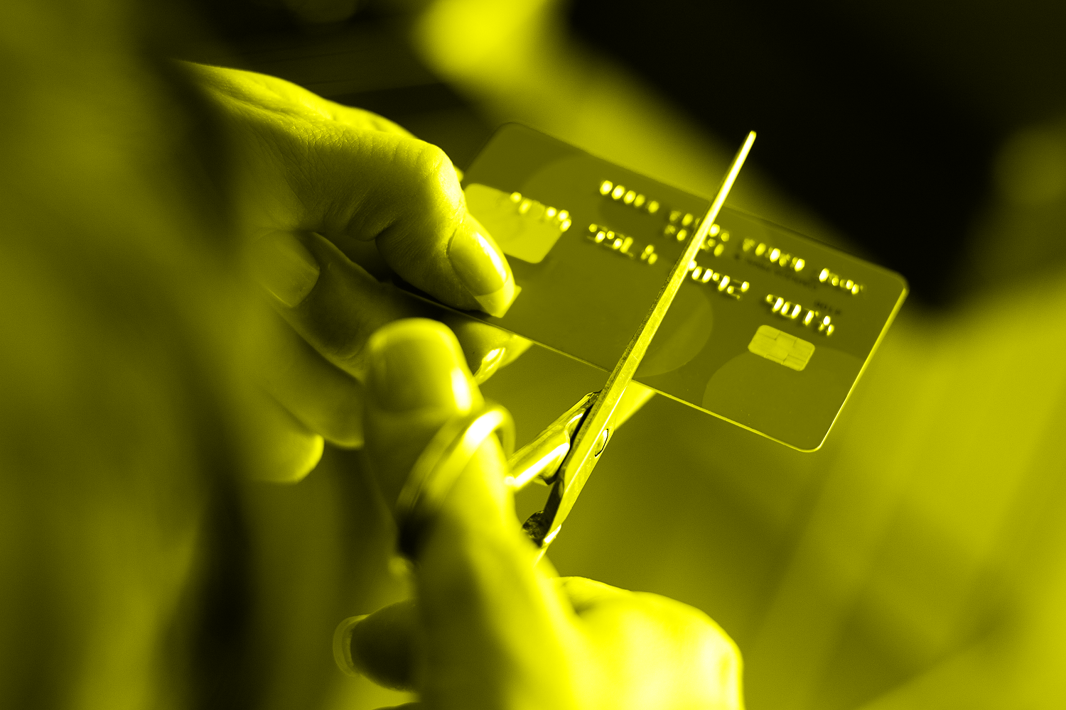 cutting debit card in half with scissors