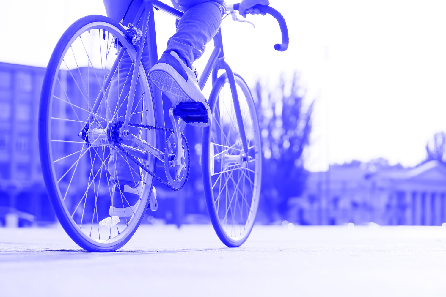 Man riding bike along road