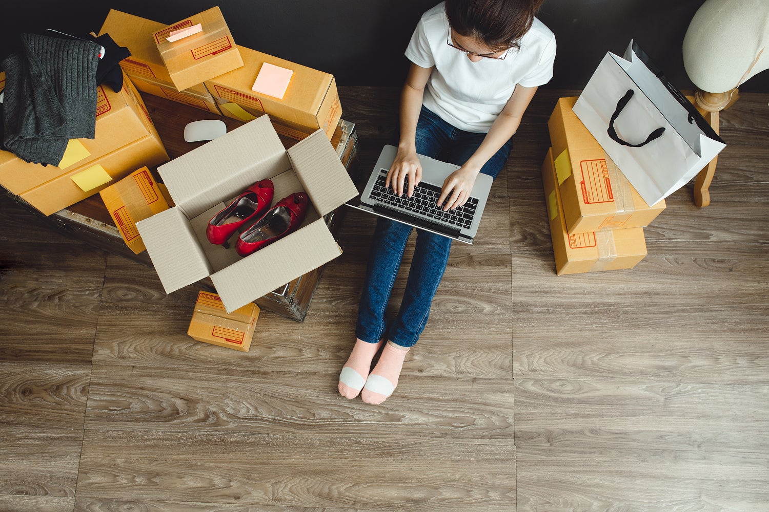 woman at home with boxes of online shopping orders